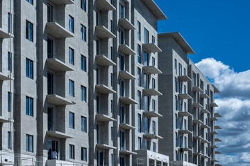 modern apartment building under construction with blue sky