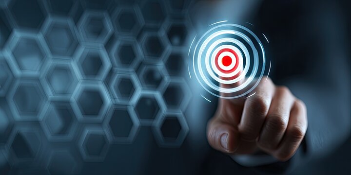A hand touches a digital target interface, with a blurred hexagonal background