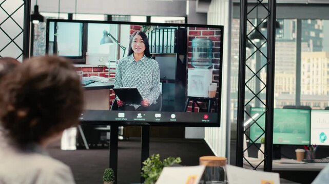 Diverse HR staff hosting a virtual meeting to interview a candidate via web video conference, discussing the job application and professional background of the person for a potential fit. Camera B.