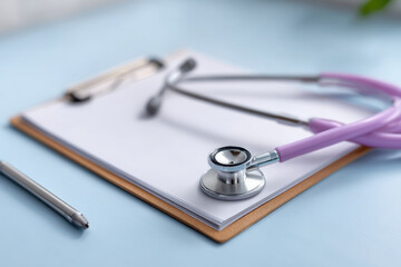 Medical equipment for doctor checking pregnant woman. purple stethoscope and clipboard ready for health examination and diagnosis at hospital clinic for prenatal care