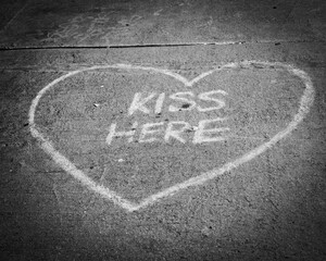 heart kiss here chalk art on sidewalk