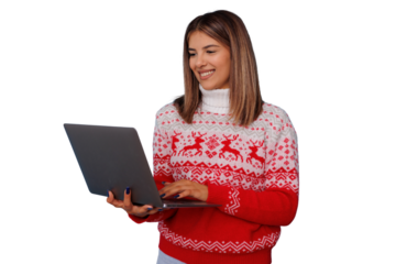 Young woman shopping online for christmas holidays, browsing internet on laptop, wearing festive winter sweater