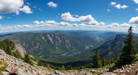 Panoramic view of mountain range under a bright blue sky with white clouds