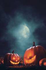 Illuminated pumpkins glowing against a dramatic moonlit sky evoke the spooky spirit of Halloween night.