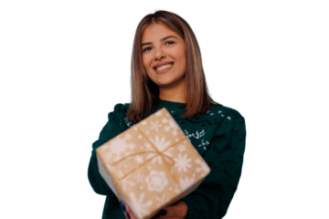 Young woman happily giving christmas gift, wearing holiday sweater, smiling for winter celebration