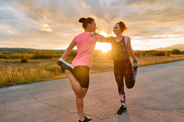 Two Women Athletes Stretching at Sunset in Beautiful Natural Surroundings