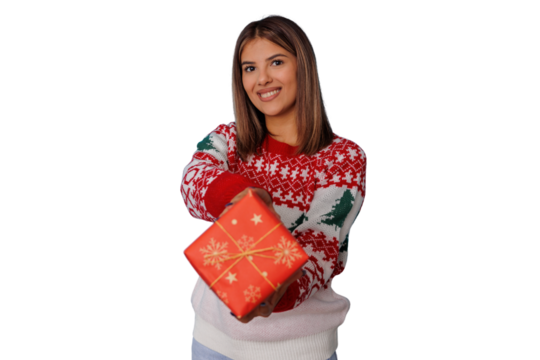 Young woman smiling, offering a christmas gift, wearing holiday sweater, celebrating seasonal tradition on transparent background