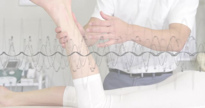 Therapist lifting patient leg on therapy table, testing foot rotating waveform overlay moving ankle