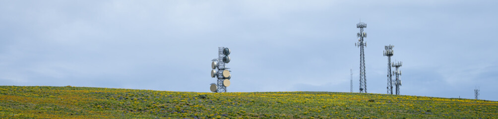 Wireless communication antennas and towers, cell sites, on a central Washington hilltop covered in...