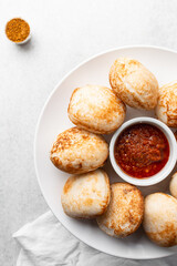 Overhead view of a plate of masa and pepper sauce, top view of food from northern nigeria masa rice cake and stew, nigerian ethnic foods