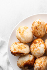 Overhead view of a plate of masa, top view of food from northern nigeria masa rice cake, nigerian ethnic foods
