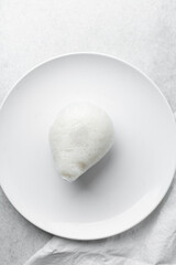 Overhead view of tuwon on a white plate, top view of northern rice swallow or tuwon shinkafa