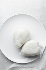 Overhead view of tuwon on a white plate, top view of northern rice swallow or tuwon shinkafa