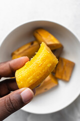 overhead view of Boiled ripe plantain in a white bowl, top view of nigerian cooked ripe plantain