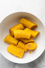 overhead view of Boiled ripe plantain in a white bowl, top view of nigerian cooked ripe plantain