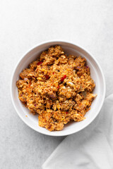 Overhead view of tomato scrambled eggs in a white bowl, top view of egg fried in tomato sauce