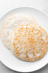 Overhead view of a plate of sinasir, top view of food from northern nigeria sinasir rice pancake, nigerian ethnic foods