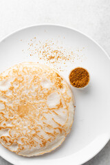 Overhead view of a plate of sinasir with yaji, top view of food from northern nigeria sinasir rice pancake, nigerian ethnic foods