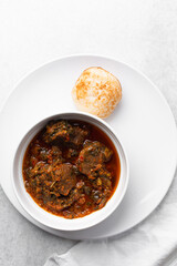 Overhead view of a plate of masa and miyan taushe, top view of food from northern nigeria masa and taushe, nigerian ethnic foods