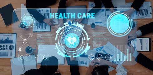A professional team collaborates in a modern office setting using advanced technology for data analysis in health care. Digital interfaces illustrate health statistics. Trope