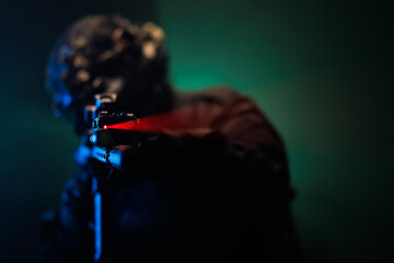 Close-up of a Tactical Soldier Aiming a Weapon with Laser Sight © Nikola Spasenoski