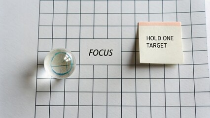 Clear Marble On Grid Paper And Focus Note With Message