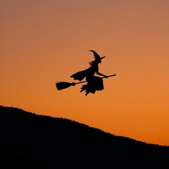 Elegant Witch Silhouette Against an Orange-to-Black Gradient Sky