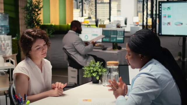 Recruitment process with CV document evaluation in a corporate job interview, black businesswoman asking candidate questions based on his past work experience and studies shown on paper. Camera A.