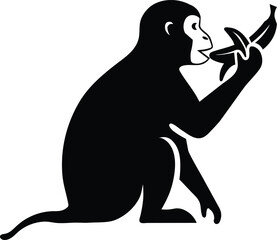 Obraz premium A detailed black silhouette of a monkey sitting down and eating a banana presented in a simple graphic style silhouette