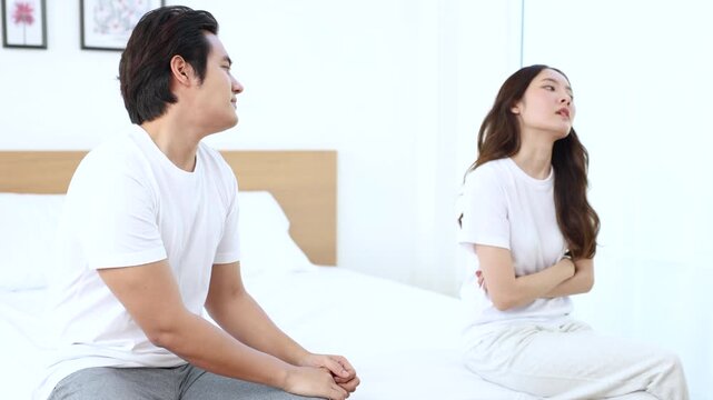 Couple facing problem, emotional sadness during relationship crisis, misunderstanding unresolved, married Asian partners in bedroom silence, emotional quiet tension, intimacy broken, hurt expression