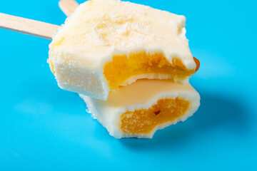 half eaten shredded pork popsicles on a blue background
