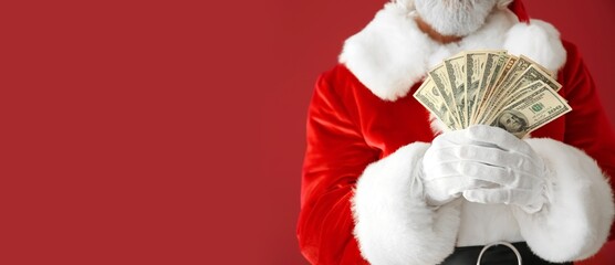Santa Claus holding money on red background with space for text, closeup