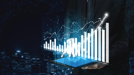 A professional in business attire analyzes data through a tablet, showcasing graphs and growth trends in a modern urban setting, emphasizing digital innovation. Impute