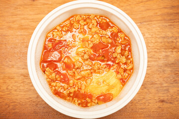 top view bowl of tomato meat sauce rice with egg