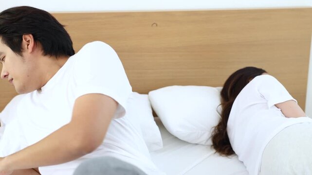 Couple facing problem, emotional sadness during relationship crisis, misunderstanding unresolved, married Asian partners in bedroom silence, emotional quiet tension, intimacy broken, hurt expression