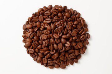 A top-down view of a heaping pile of coffee beans on a white background