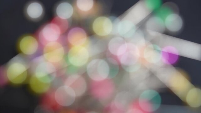 Image of bokeh created by zooming in to focus on a colorful pinhead.