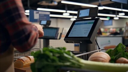 Modern shopper using smartphone for contactless payment at self-checkout kiosk, streamlining grocery shopping with digital convenience and efficiency - Powered by Adobe