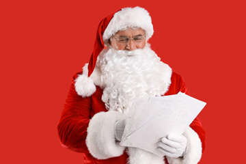 Santa Claus with letters on red background