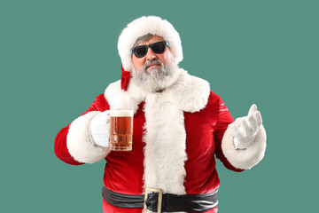 Bad Santa Claus with beer on green background