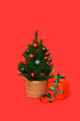 Small Christmas tree with gifts on red background