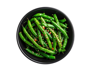 A dark bowl contains sauteed green beans, seasoned with red flakes and sesame seeds