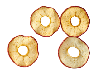 Four dried apple slices with circular holes, on black