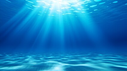 Obraz premium Sunlight pierces the tranquil, blue depths of a serene ocean, illuminating the sandy seabed below.