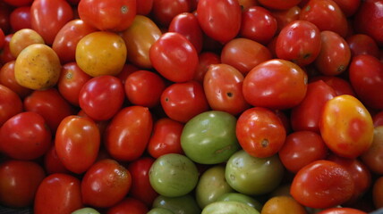 A pile of red tomatoes used as a cooking spice sold in a traditional market. Tomatoes contain many vitamins that are good for your health.