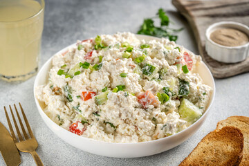 Cottage cheese salad with cucumber, tomato and herbs