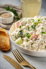 Homemade cottage cheese salad with cucumber, tomato and bread toast