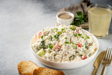 Fresh cottage cheese salad with vegetables and bread toast