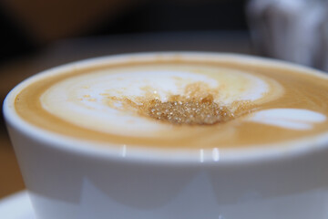 Coffee with sugar creating a swirl effect in cup