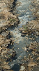 Obraz premium Aerial view of rocky coastline with narrow water channels and reflections in shallow ocean water du daytime
